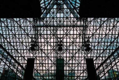 Intricate steel and glass grid structure of a modern building in Tokyo.
